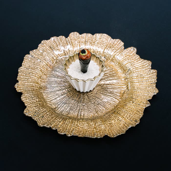A course presented on a gold radial charger