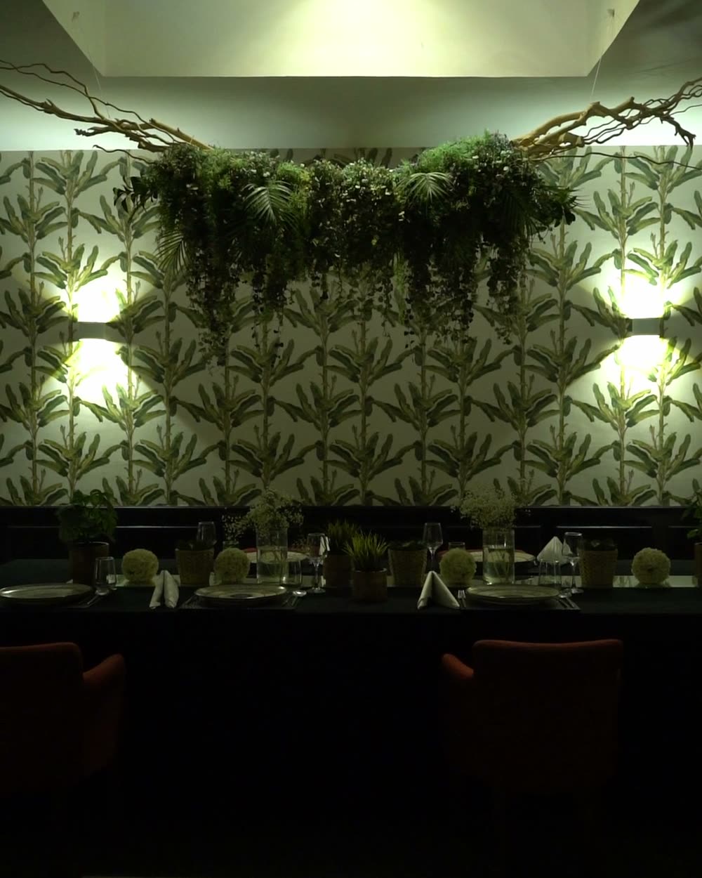 Jungle Room with palm-print walls and hanging greenery